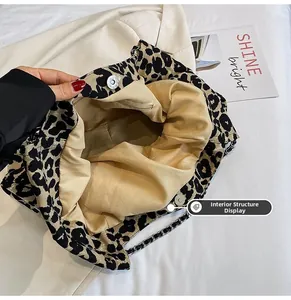 Detailed interior of leopard print canvas tote bag showing zipper pocket and magnetic snap