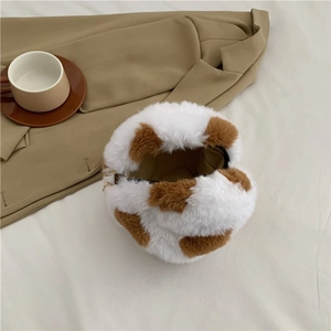 Round cow print faux fur crossbody bag with chain detail for winter fashion
