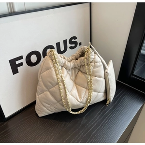 Quilted cream shoulder bag featuring gold chain strap and a matching detachable coin purse
