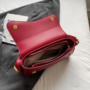 Elegant red litchi grain leather crossbody bag with multiple interior compartments