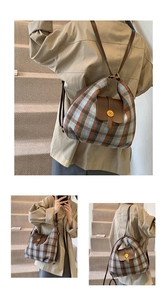 Detail of vintage plaid multiway bag with premium leather trim and golden metal buckle
