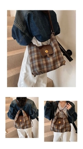 Detail of vintage plaid backpack with brown leather flap and golden N buckle closure