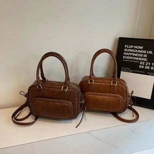 Retro brown PU leather boston handbag with adjustable straps in a minimalist casual style