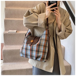 Detail of checkered plaid crossbody bag with leather flap and golden N-logo buckle