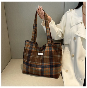Close-up of vintage plaid wool tote bag featuring brown and orange checkered patterns