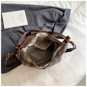 Classic quilted tote bag with brown leather handles and spacious interior pockets