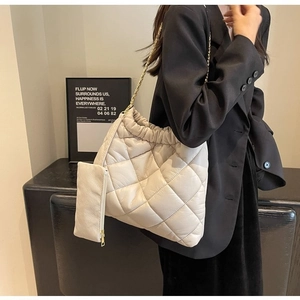 Quilted beige shoulder bag with gold chain strap and matching small zipper pouch