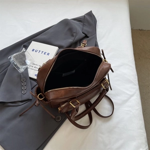Minimalist vintage dark brown leather handbag with gold zipper and stylish top handles