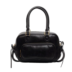 Minimalist black faux leather handbag with gold hardware and front zipper pocket