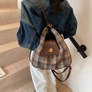 British vintage plaid backpack with brown leather flap and round gold metal buckle lock