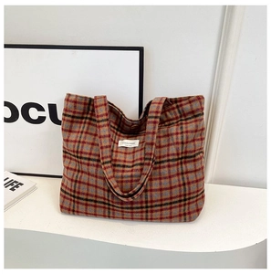 Classic multicolored plaid tote bag with textile texture and minimalist logo tag