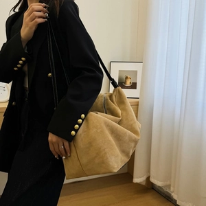 Chic camel faux suede hobo bag styled with a black blazer for urban commuter look