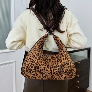 Detail shot of leopard print hobo bag showing high texture suede and wide shoulder strap