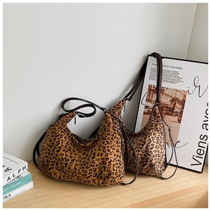 Macro detail of leopard print hobo bags showing canvas texture and brown straps