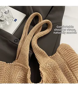 Detail of soft woven shoulder strap and thick knit texture on a khaki tote bag