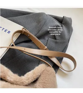 Detail of smooth brown leather adjustable shoulder strap on a plush faux fur tote bag