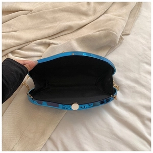Electric blue metallic shoulder bag with gold chain strap and spacious interior