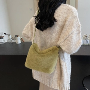 Olive green plush shoulder bag featuring soft faux fur texture and minimalist strap design