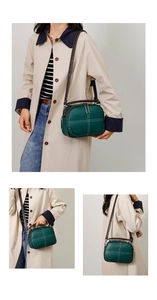 Detail of dark green leather shoulder bag with contrast white cross stitching design