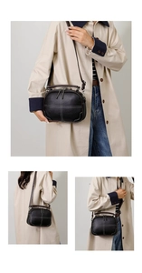 Detailed views of a black crossbody bag with contrast stitching and dual zippers