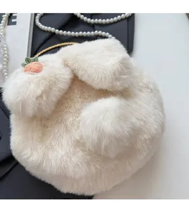 Detailed view of plush rabbit-shaped shoulder bag with soft fur and carrot embroidery