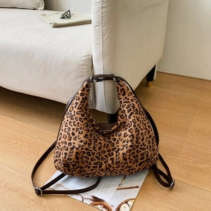 Leopard print hobo bag with adjustable leather strap on a stylish minimalist background