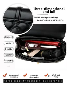 Detail view of large capacity black quilted shoulder bag interior showing organized storage