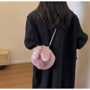 Vue arrière d'un mannequin portant un sac lapin en peluche rose avec chaîne perlée