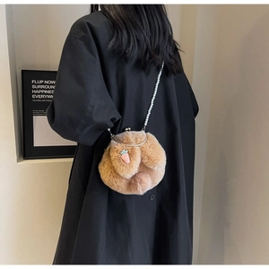 Détail d'un sac bandoulière en peluche avec broderie carotte et chaîne de perles