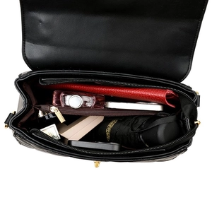 Top view showing large storage capacity of the quilted chain bag with daily items