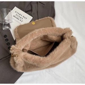 Beige faux fur tote bag with gold chain strap and spacious interior compartment