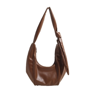 Brown leather crescent hobo bag with knotted strap and minimalist pleated design
