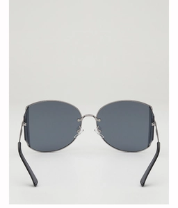 Detail of silver wavy metal frame and dark grey lenses on butterfly sunglasses