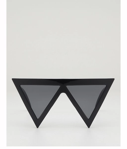 Detailed close-up of avant-garde black inverted triangle sunglasses with dark gray lenses