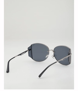 Detail view of large dark grey lenses and metallic temples with sleek cut-out design