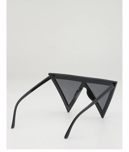 Macro view of black triangular avant-garde sunglasses with a minimalist frame design