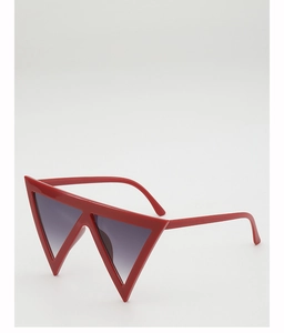 Macro side view of trendy red triangular sunglasses with gradient lenses on white backdrop