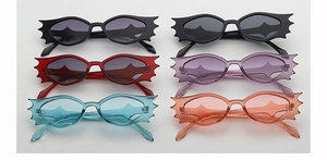 Detailed view of novelty bat-shaped sunglasses in six assorted jelly colors for parties