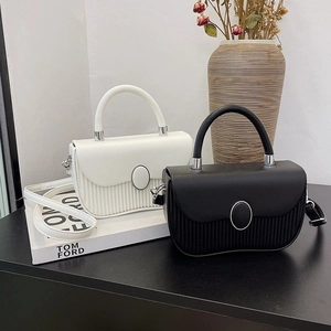 Detail of vintage square handbags with pleated texture and oval metal buckle decoration