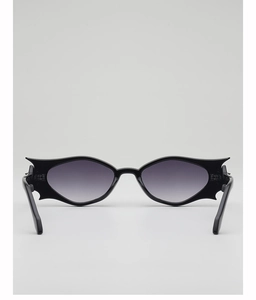 Close-up of black bat-wing sunglasses with grey gradient lenses and sturdy metal hinges