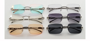 Detail of rimless Y2K sunglasses with star metal accents in six various lens colors