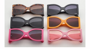 Detailed collection of wide-frame sunglasses in six diverse colors on a white background