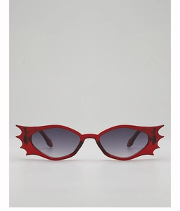 Detailed close-up of red bat-shaped rimless sunglasses with dark lenses for parties
