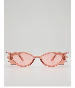 Close-up of pink translucent bat-shaped sunglasses with stylish jagged wing frames