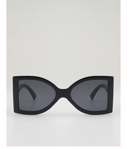 Detail of oversized black butterfly sunglasses with polished finish and dark grey lenses