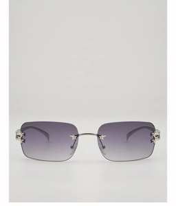 Detail of Y2K rimless sunglasses with purple gradient lenses and silver star accents