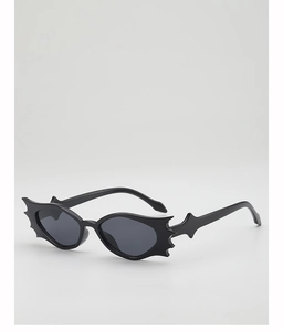 Detailed view of novelty bat-shaped sunglasses with a glossy black frame for Halloween