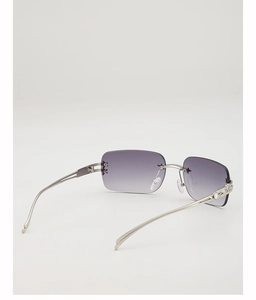 Detail view of rimless square Y2K sunglasses with purple gradient lens and star studs