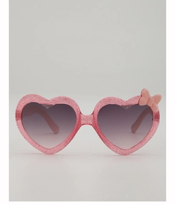 Détail de lunettes de soleil coeur rose pour enfants avec paillettes et noeud