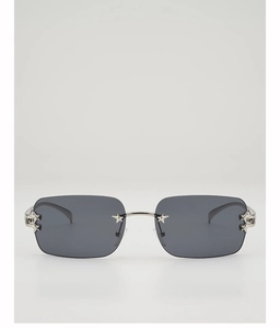 Close-up of frameless rectangle sunglasses with silver star hardware and dark grey lenses